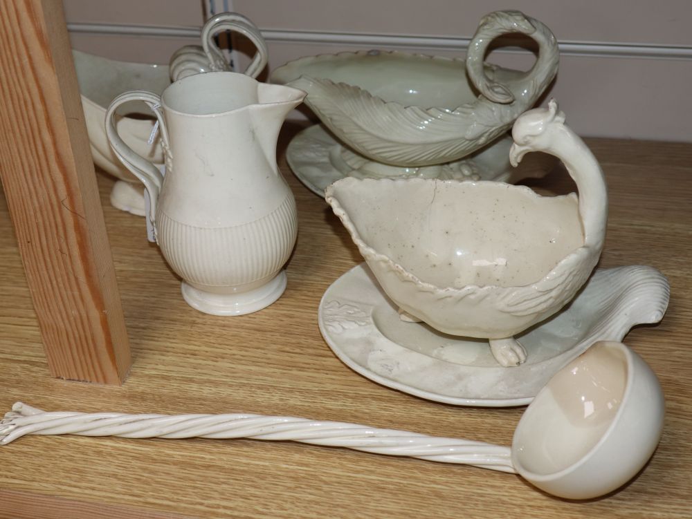 A late 18th century creamware sauce boat and stand, another similar with stand, a sauceboat, jug and ladle